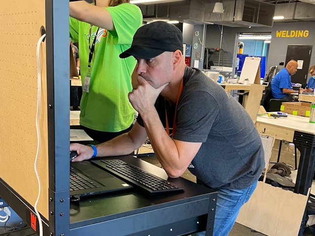 A man intently focused on editing video during the Make 48 competition.