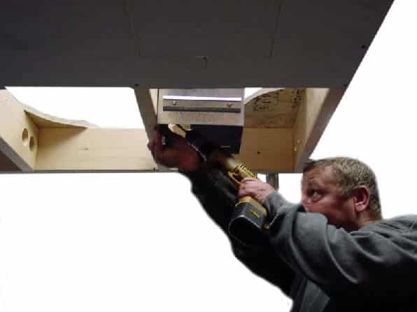 Drill goes brrr on a installation test for a new Hunter Bath Fan developed at Catalyst.