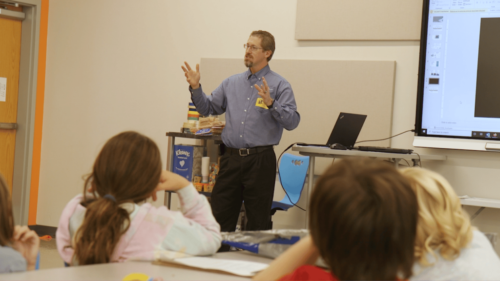 AM_1 Andrew addresses a fourth grade class just before he judges their animal prosthesis projects.