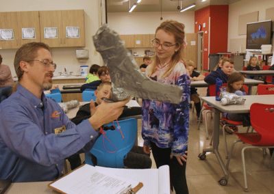 Industrial Designer gives feedback to students about their animal prosthetic prototype.