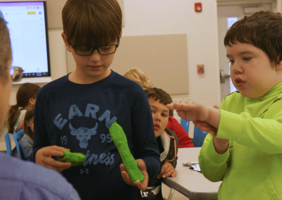 Zoom says the kid in the lime green shirt. Hmmm, says the other as Andrew discusses their class project on animal prosthesis.