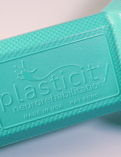 Close up of the texturing and logo of the Polyform-1h, a bi-manual neurorehabilitation device.