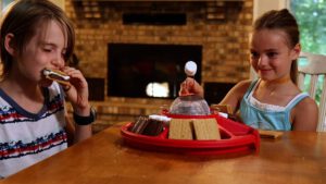 Children make S'mores indoors with a Sterno product.