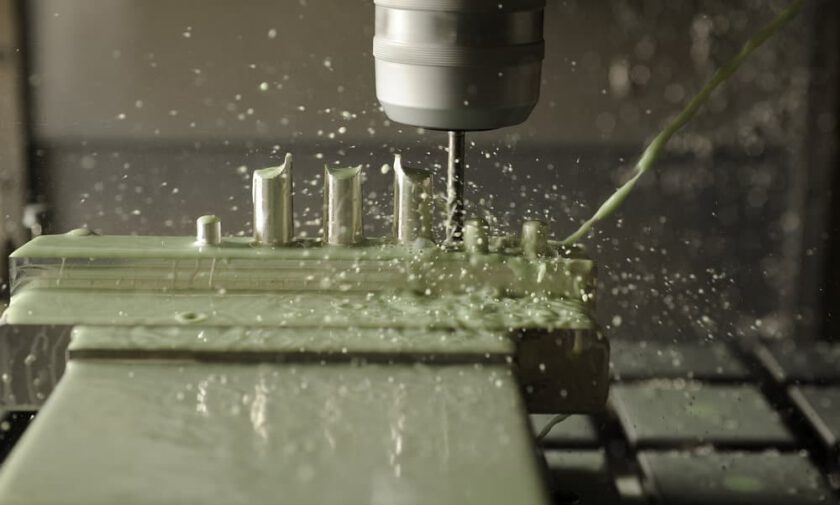Contact between a CNC mill end and a block of aluminum.