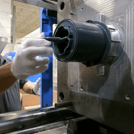 A plastic injection molded component for the Heinz ReMix comes off the press at Catalyst.